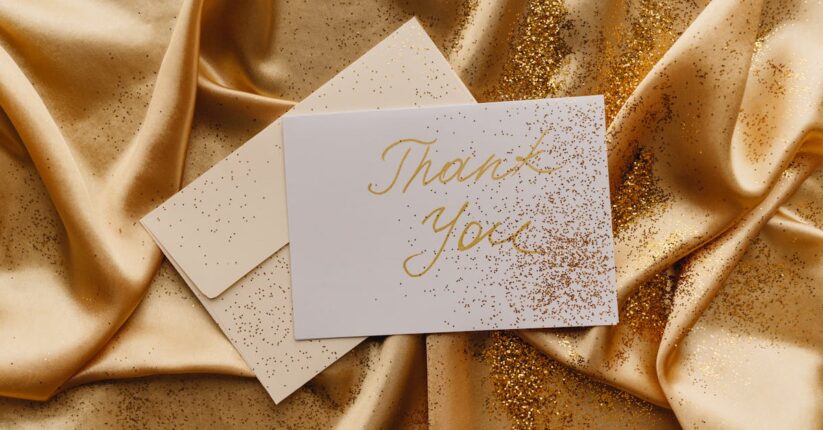 結婚式の席札に友人へのメッセージを書いている花嫁。カジュアルで温かい雰囲気のテーブル。